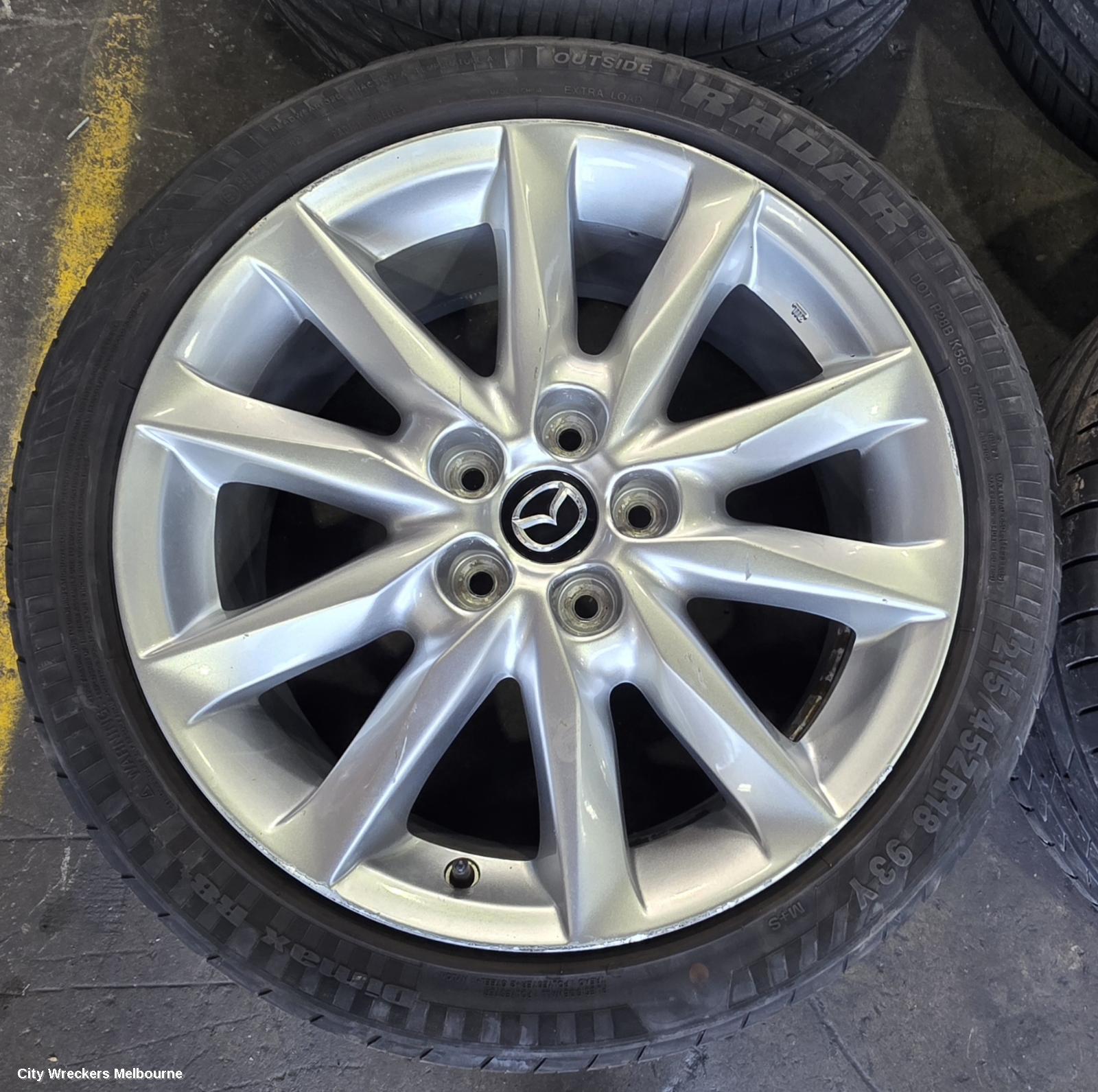 MAZDA 3 WHEEL MAG, FACTORY, 18X7IN, LIGHT GREY, BN, 05/2016 - 02/2019
