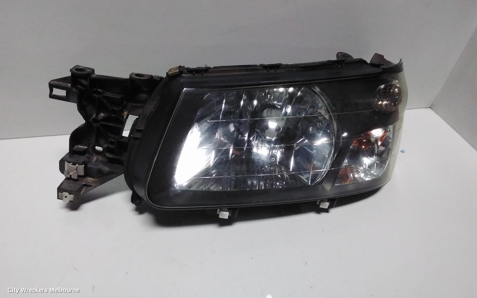 SUBARU FORESTER LEFT HEADLAMP, BLACK INSERT (CURVED LINES), LENS# 1700, 08/2004 - 05/2005