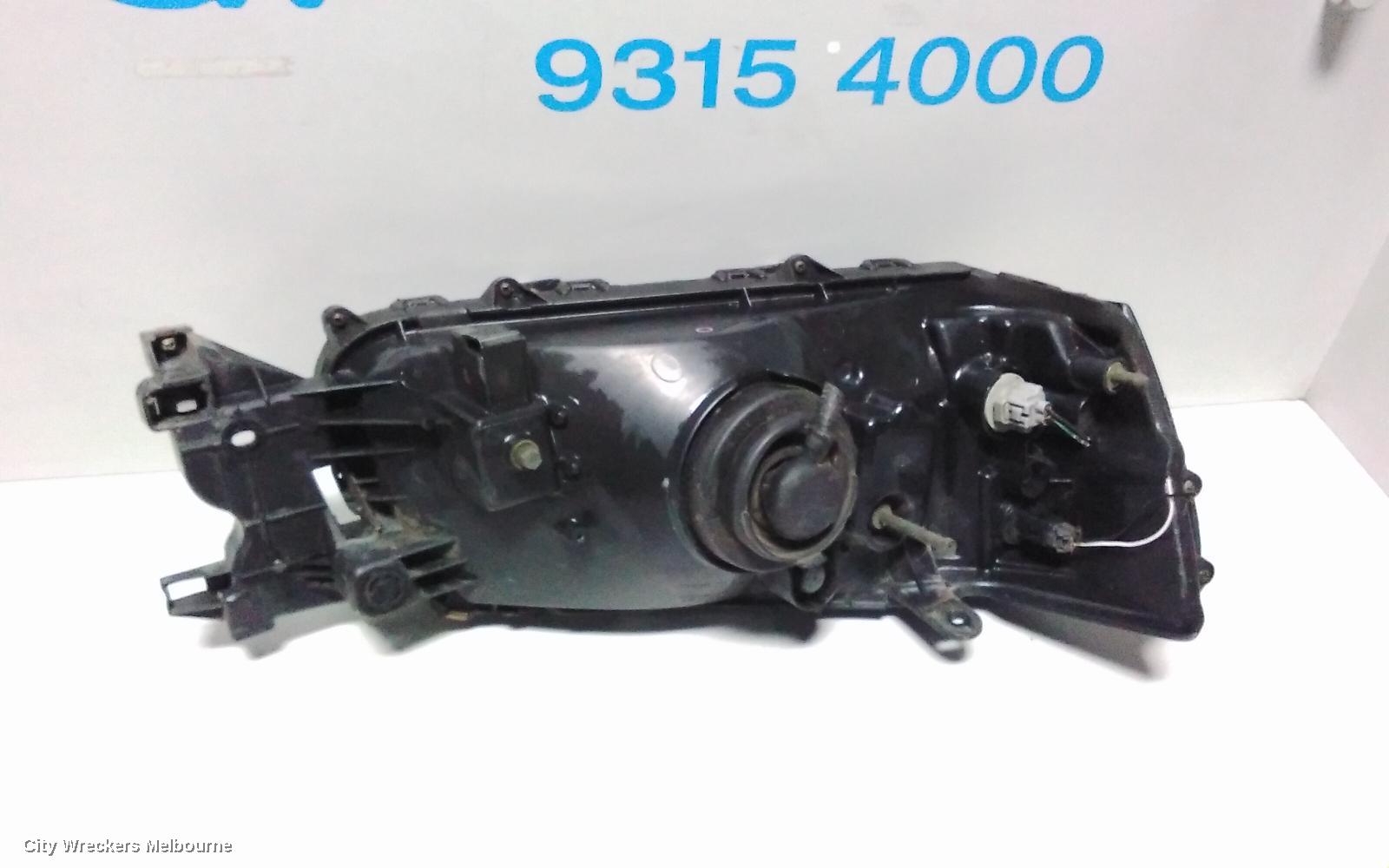 SUBARU FORESTER LEFT HEADLAMP, BLACK INSERT (CURVED LINES), LENS# 1700, 08/2004 - 05/2005