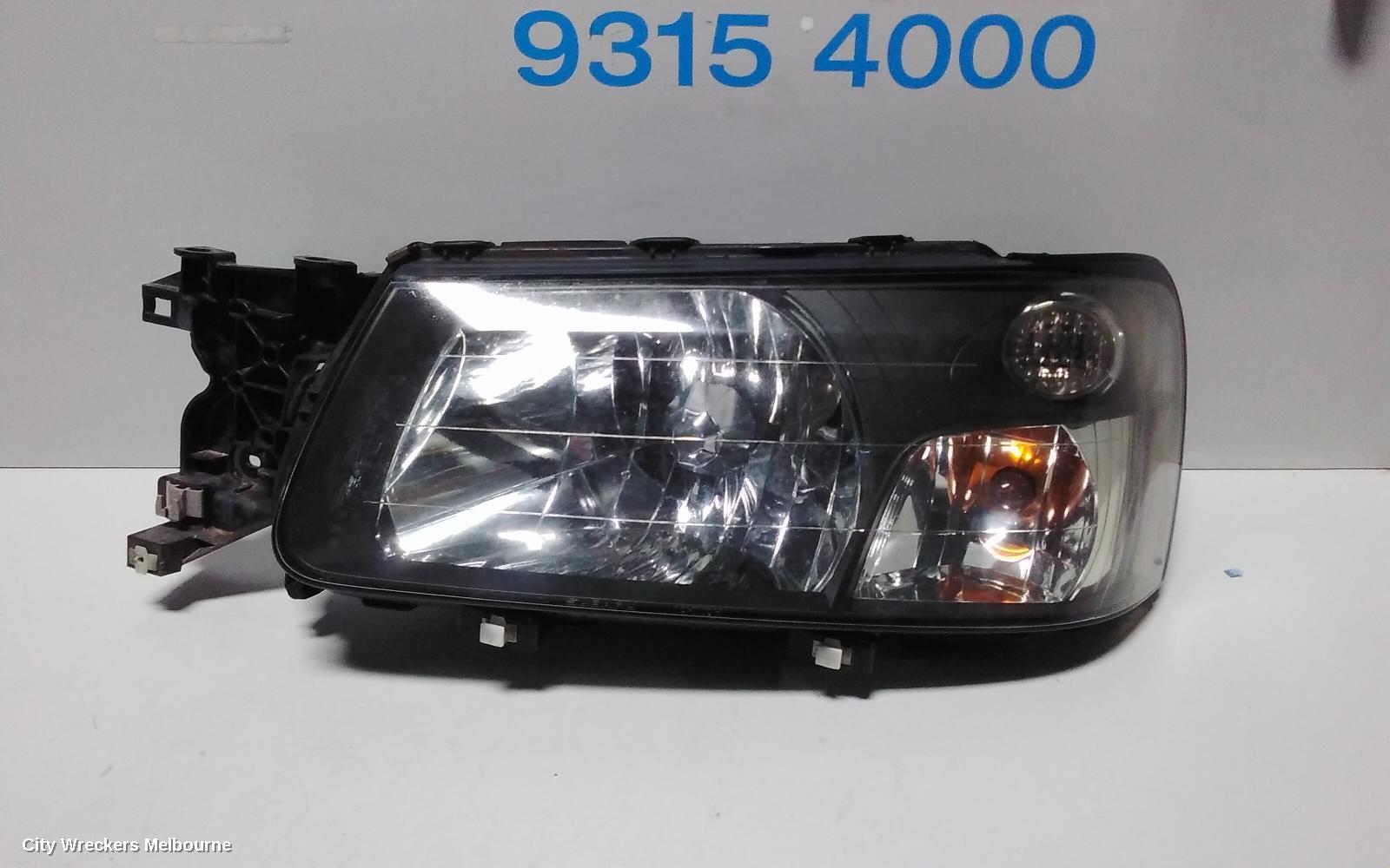 SUBARU FORESTER LEFT HEADLAMP, BLACK INSERT (CURVED LINES), LENS# 1700, 08/2004 - 05/2005