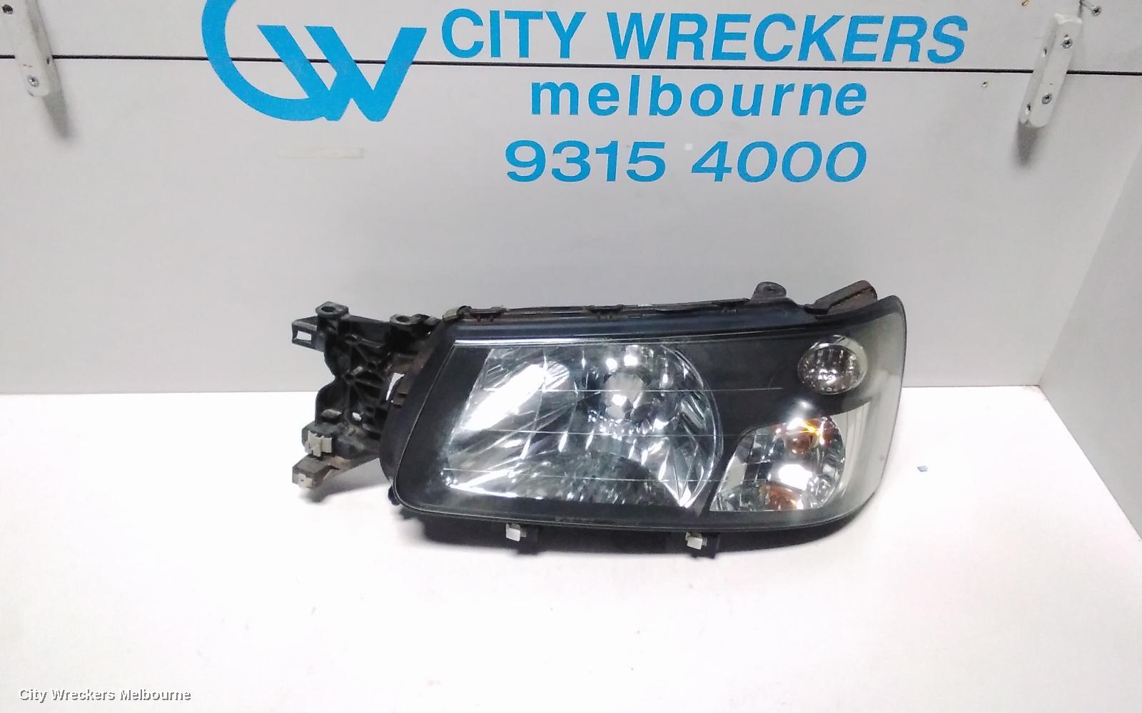 SUBARU FORESTER LEFT HEADLAMP, BLACK INSERT (CURVED LINES), LENS# 1700, 08/2004 - 05/2005