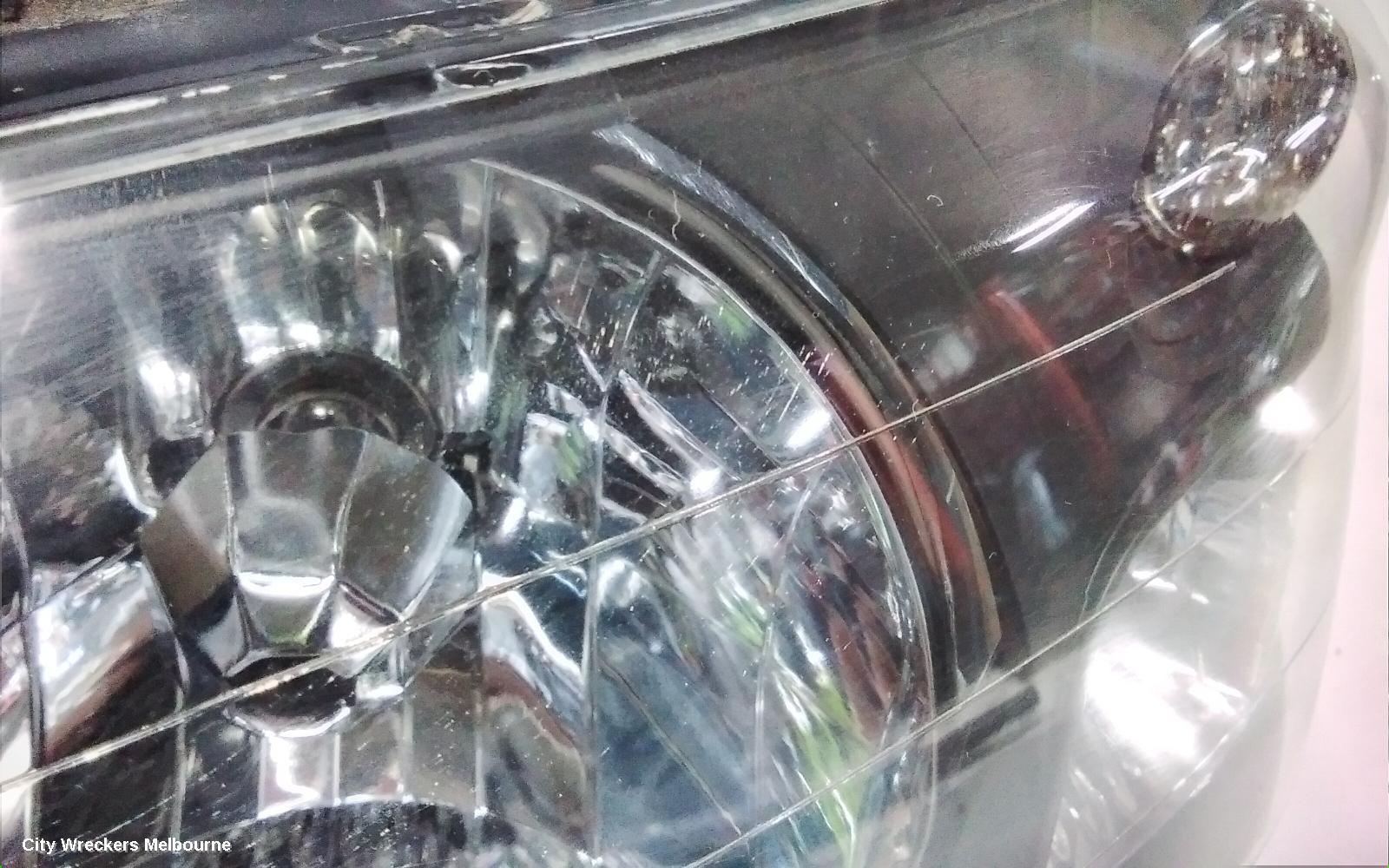 SUBARU FORESTER LEFT HEADLAMP, BLACK INSERT (CURVED LINES), LENS# 1700, 08/2004 - 05/2005