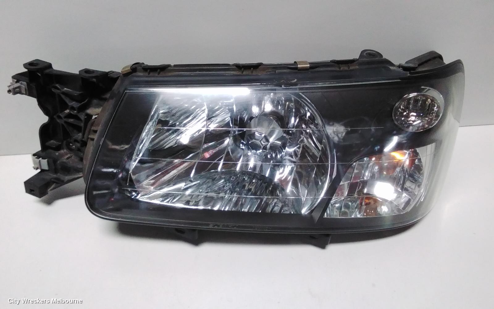 SUBARU FORESTER LEFT HEADLAMP, BLACK INSERT (CURVED LINES), LENS# 1700, 08/2004 - 05/2005