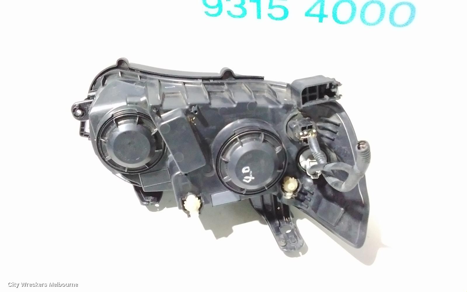 HOLDEN BARINA LEFT HEADLAMP, TM, W/ CHROME RING TYPE, 08/2011 - 08/2016