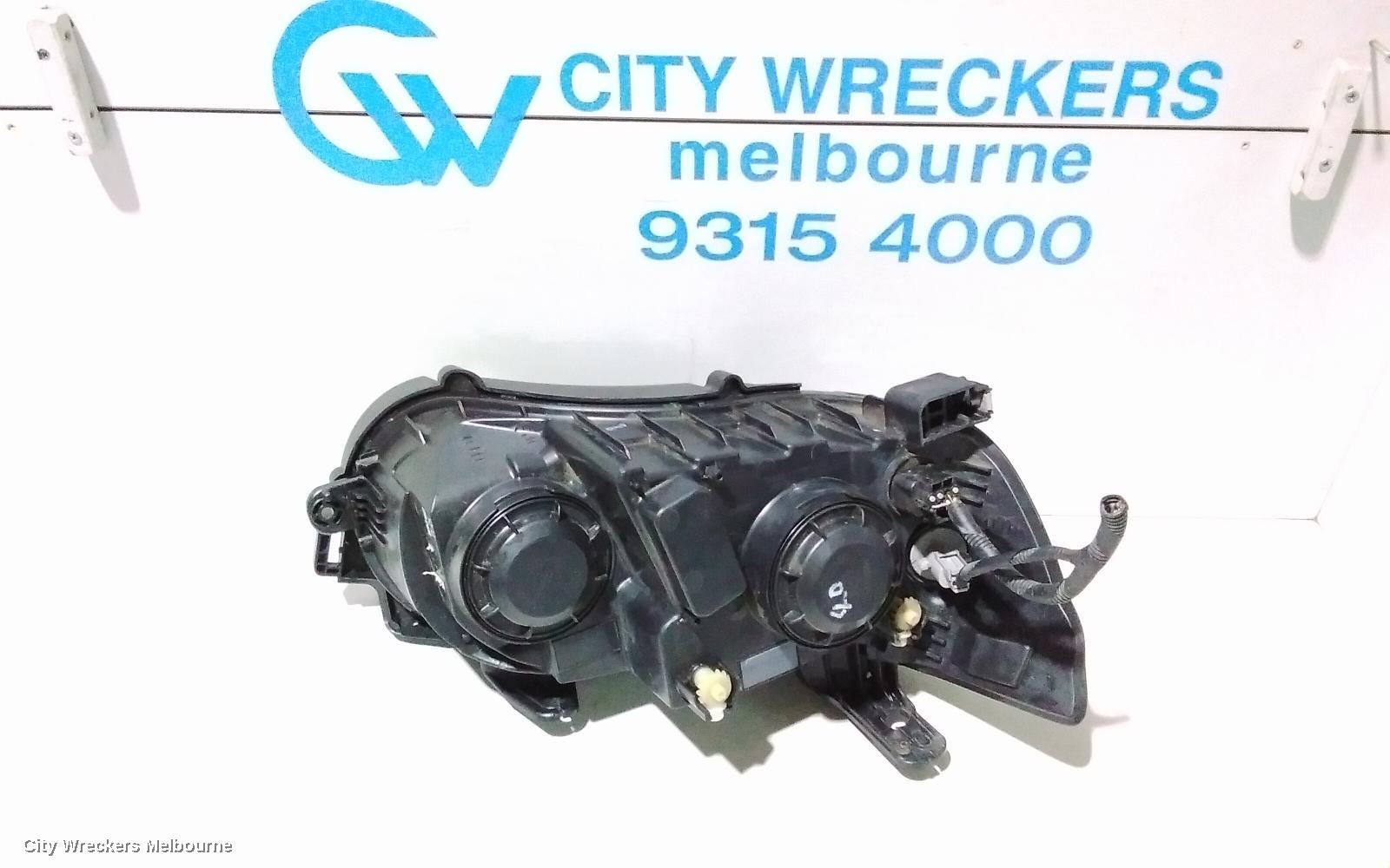 HOLDEN BARINA LEFT HEADLAMP, TM, W/ CHROME RING TYPE, 08/2011 - 08/2016